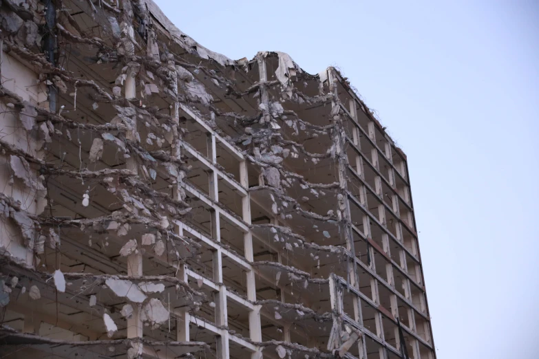 a large building that is almost covered in broken plaster