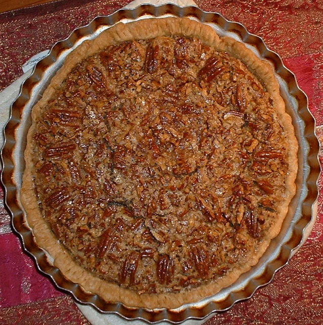 a pie with various toppings sitting on top of a table