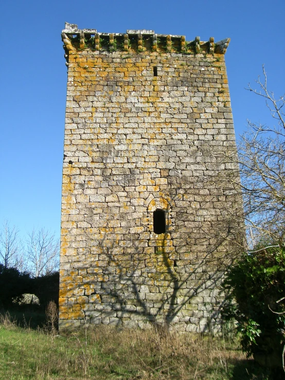 an old brick building with a small window in the side