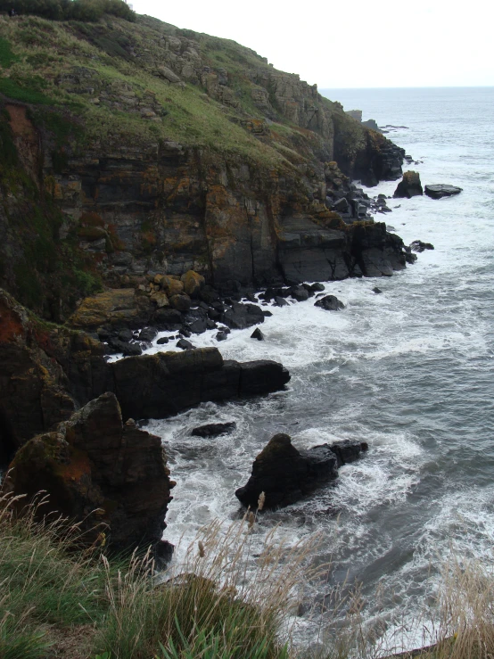 view of the ocean from high above some cliffs