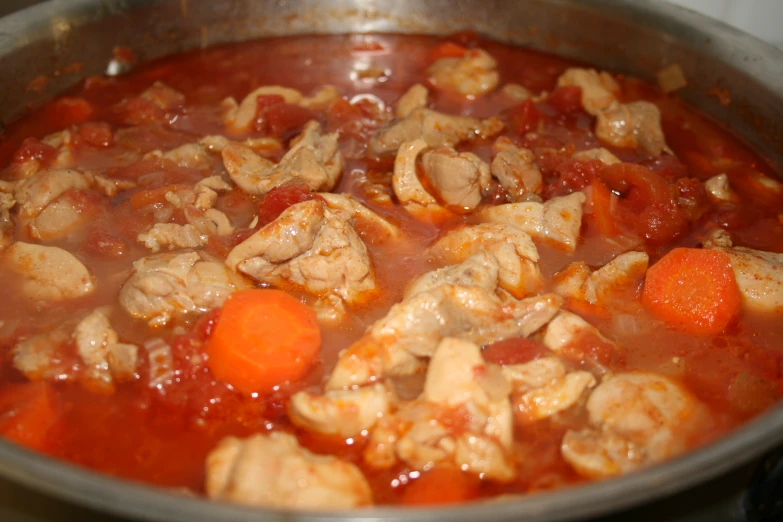 a bowl full of vegetables and meat in a broth