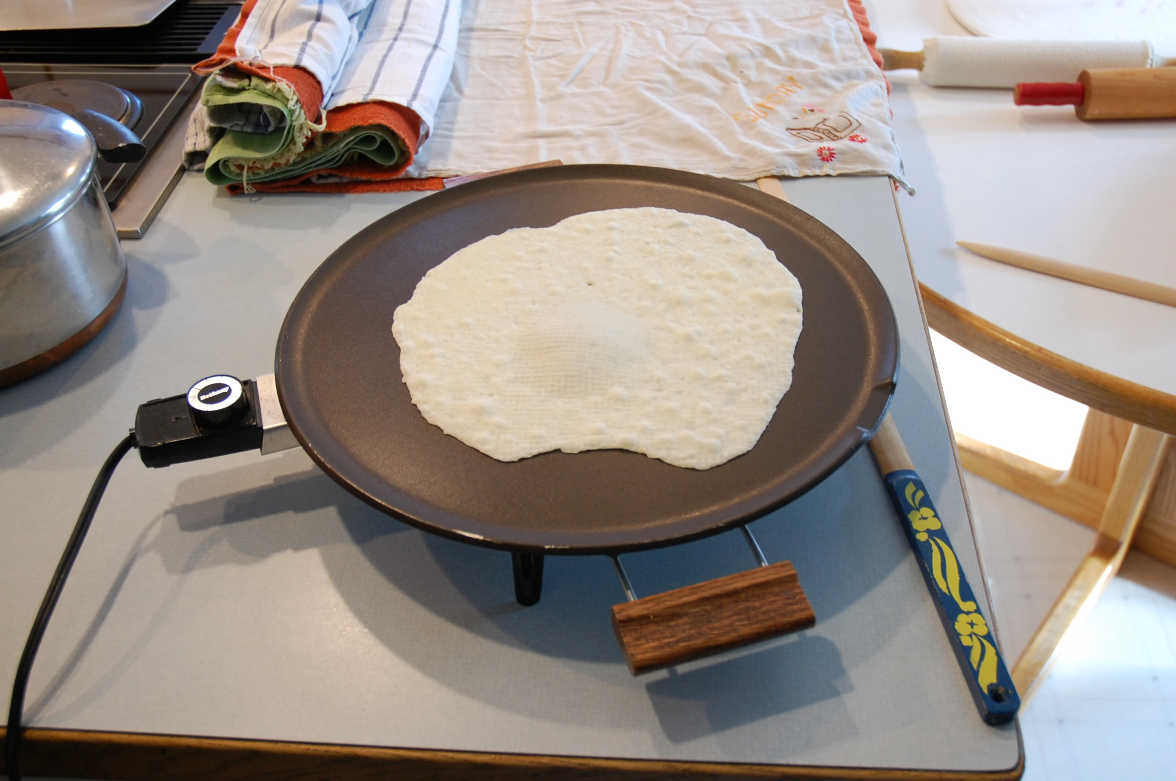 an uncooked pizza is being prepared on a stove