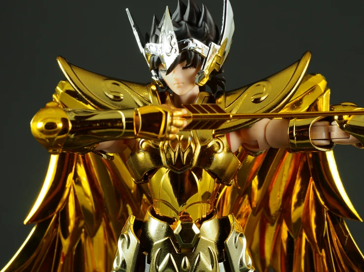 a golden model with many gold wings and armor