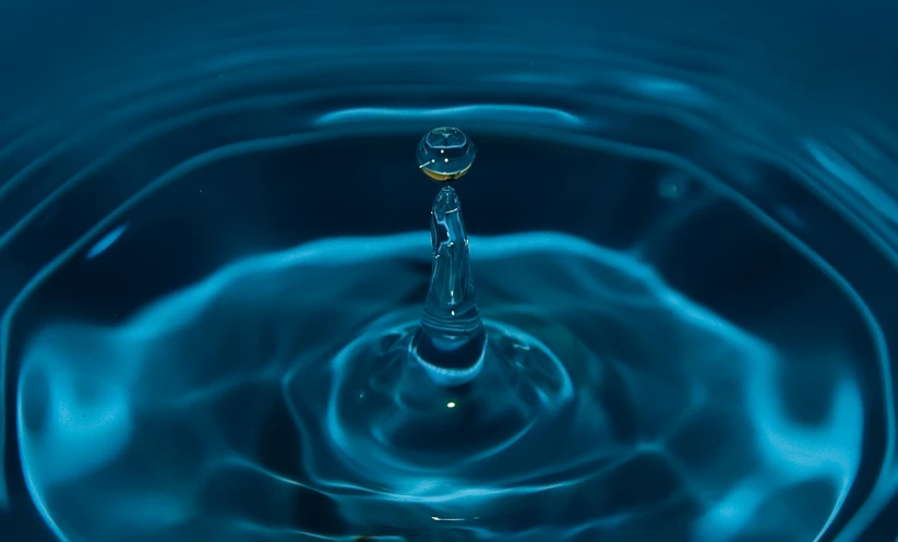 a water drop in front of the light and shadow