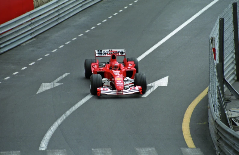 a race car on a road near a barrier