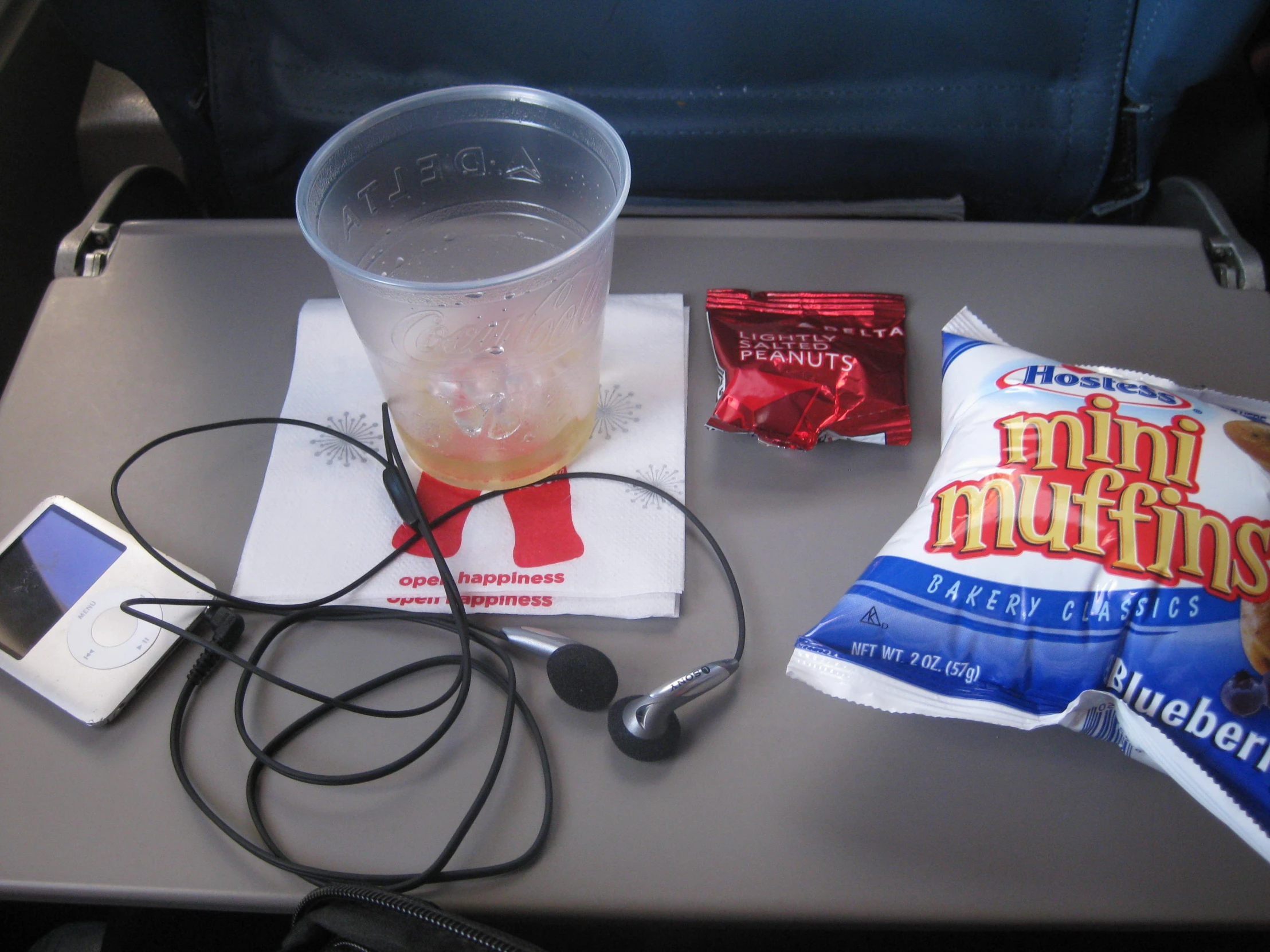 there is some snacks and headphones on a table