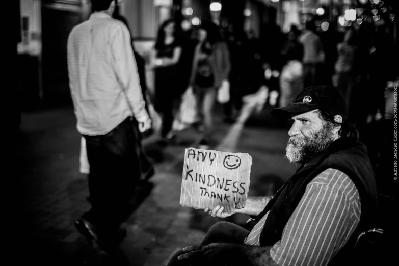 a man sitting in a chair holding a sign