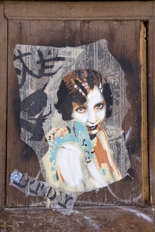 an altered pograph on wood shows a woman wearing a scarf