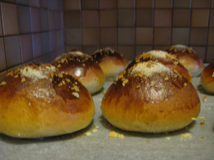 bread rolls with sugar sprinkled on top of them sitting in the oven