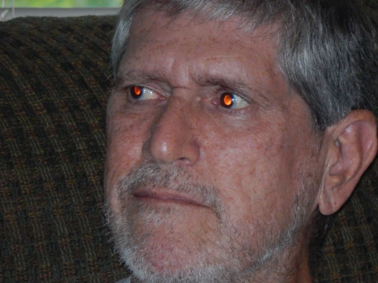 the man has white hair and red eyes