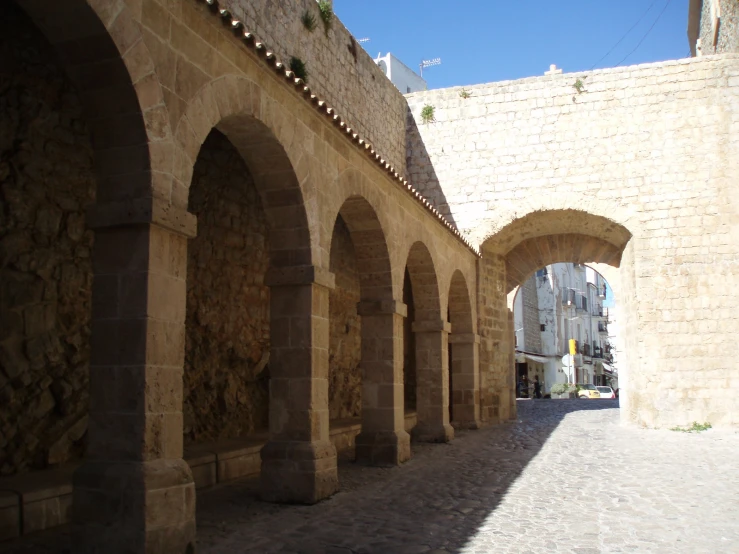 a long row of arches on a stone building