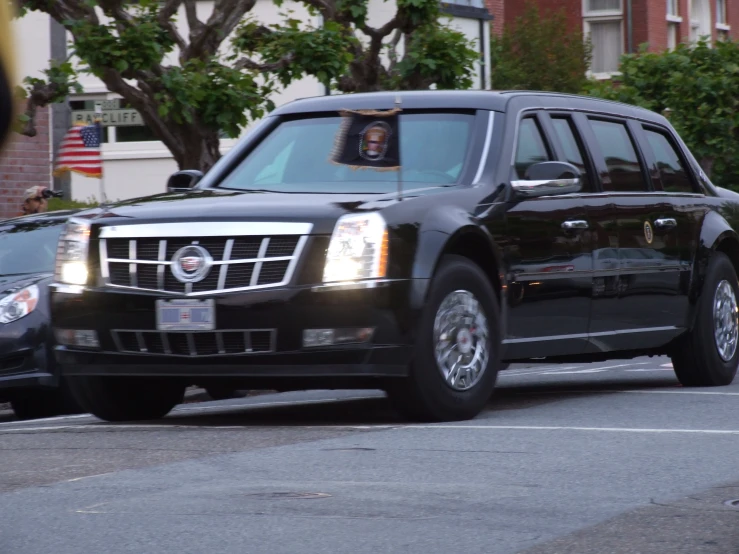the limousine is driving down the road behind the other cars