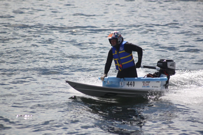 man wearing a life vest and a life vest kayaks on a lake