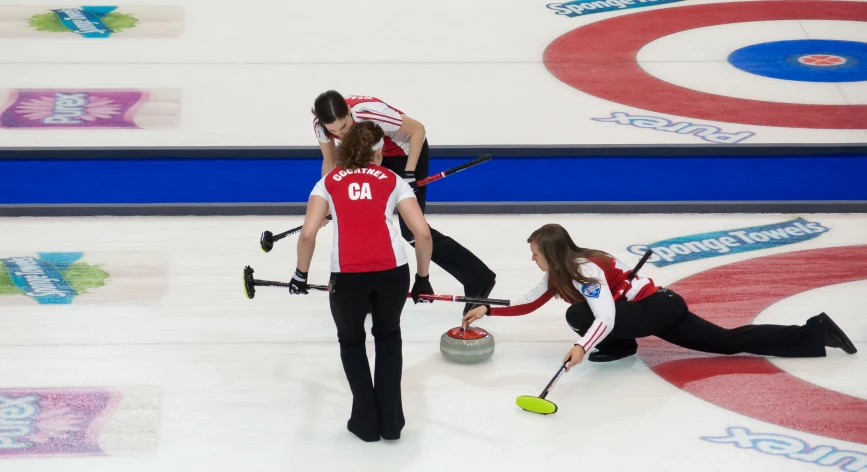 two women are curling and some have their heads down