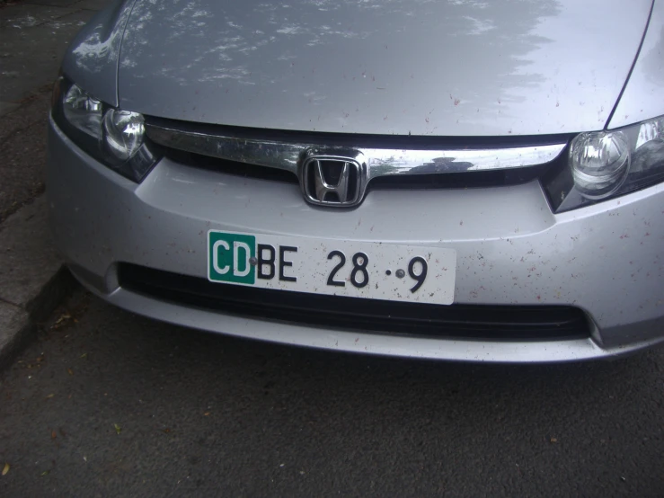 a license plate for an older car sitting on the street