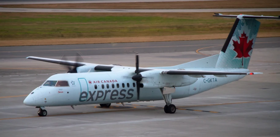 there is a large propeller plane on the runway