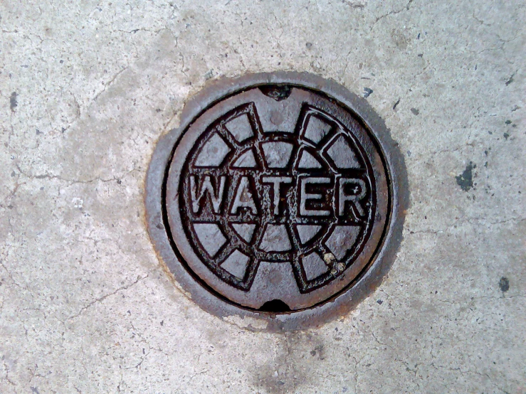 a drain cover that has the word water written on it