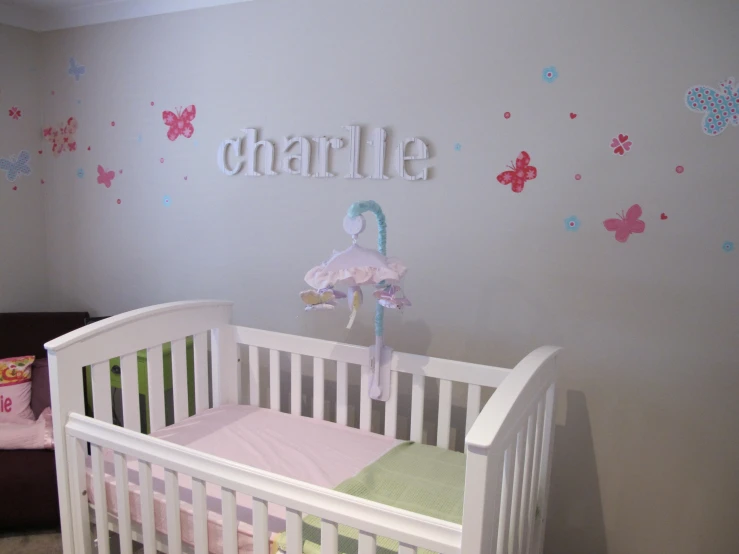 a baby room with a crib and a chair