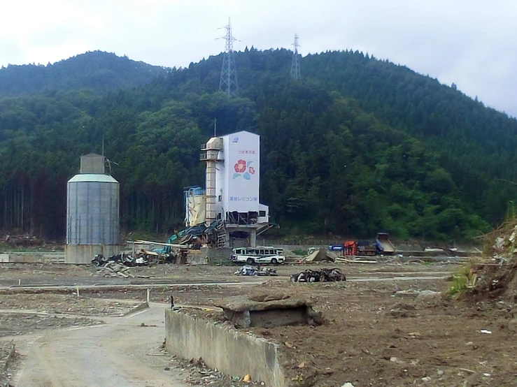 the construction of a large silo by a tree