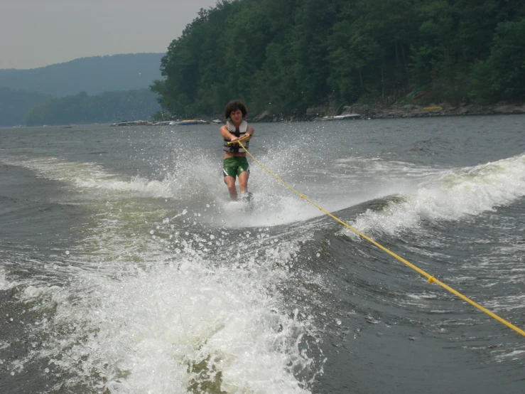 a young man on water skis going over a ramp
