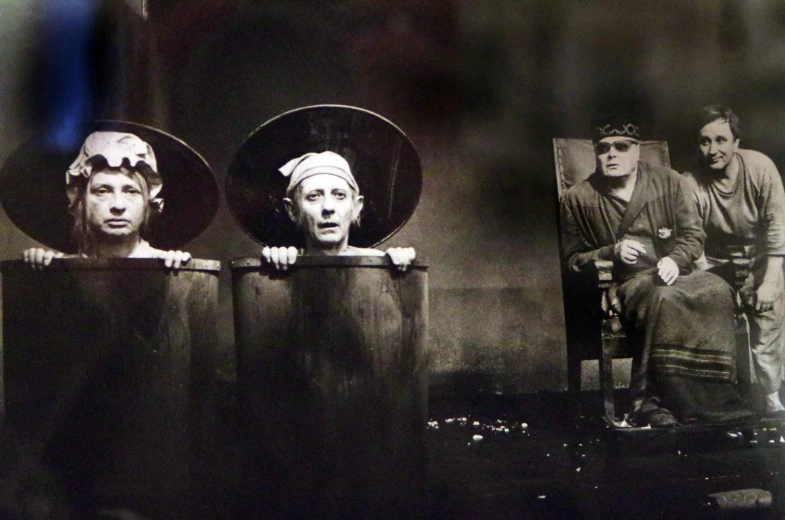 three actors sit on their chairs in front of an image of the same woman