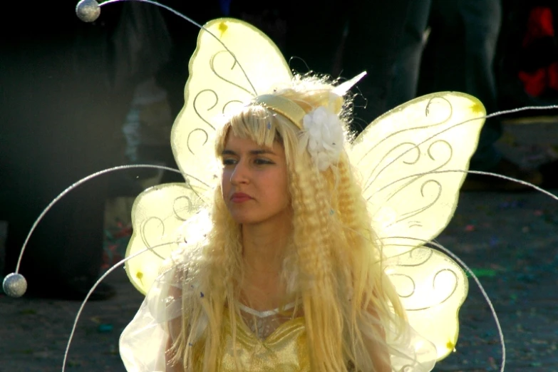 a woman with very long hair wearing fairy wings