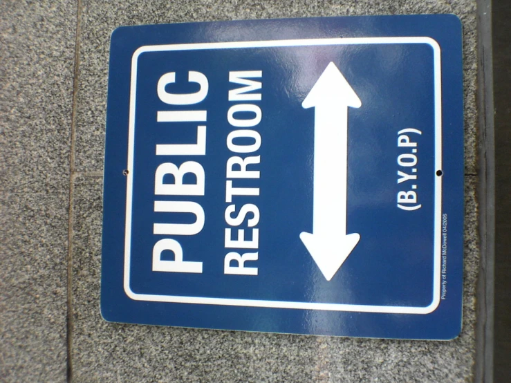 a public restroom sign is posted on the wall