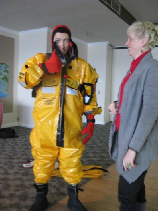 the woman is wearing a yellow rain suit