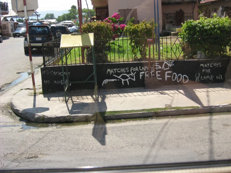 graffiti is written on the outside fence of a street