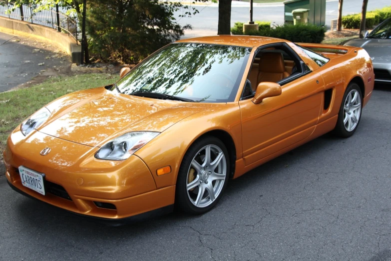 an orange sports car parked in a lot