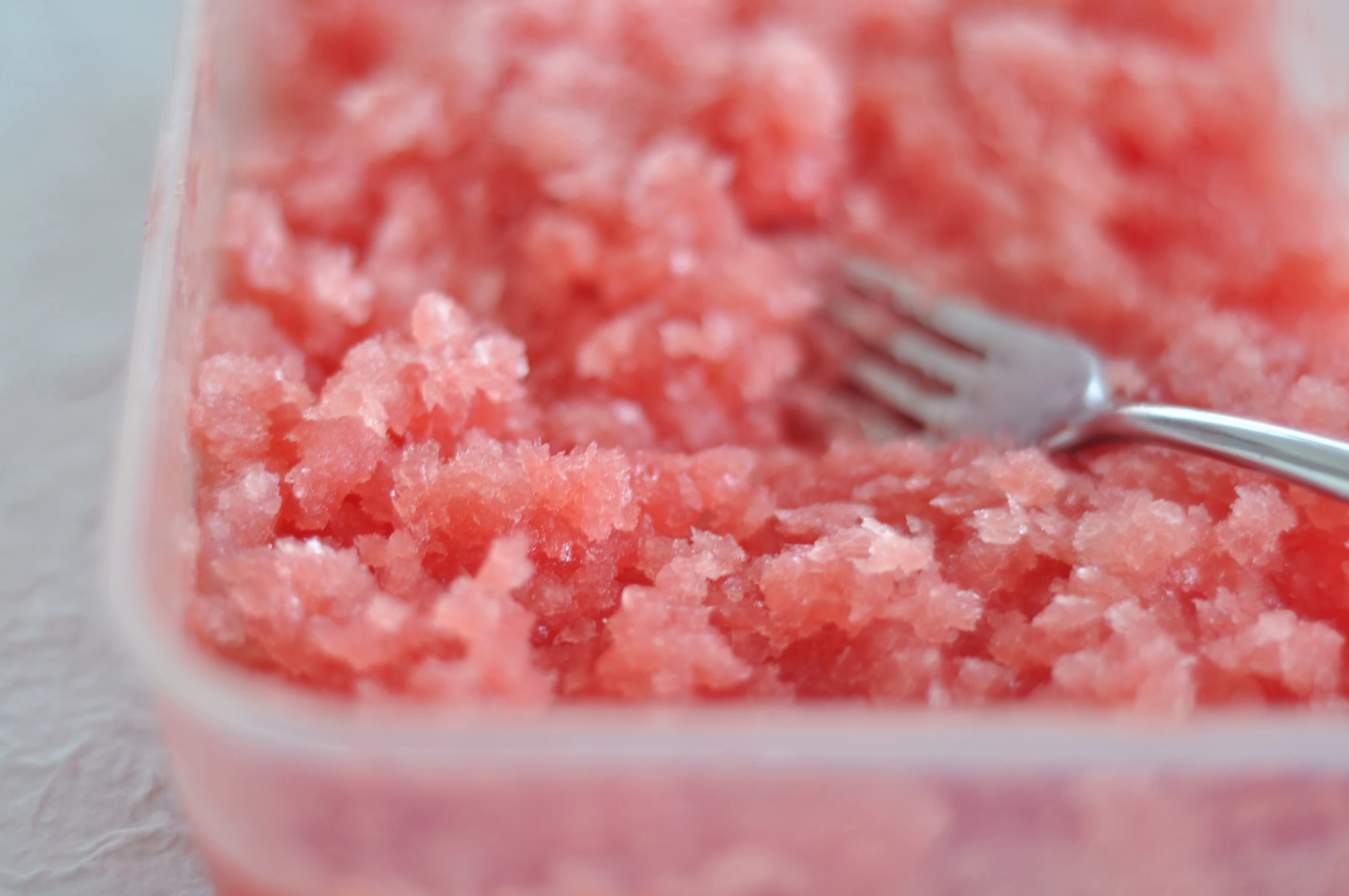 a fork is sticking into pink and white cereal