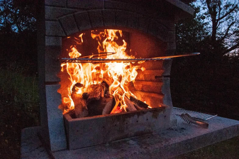 a stone oven with flame and flames inside of it