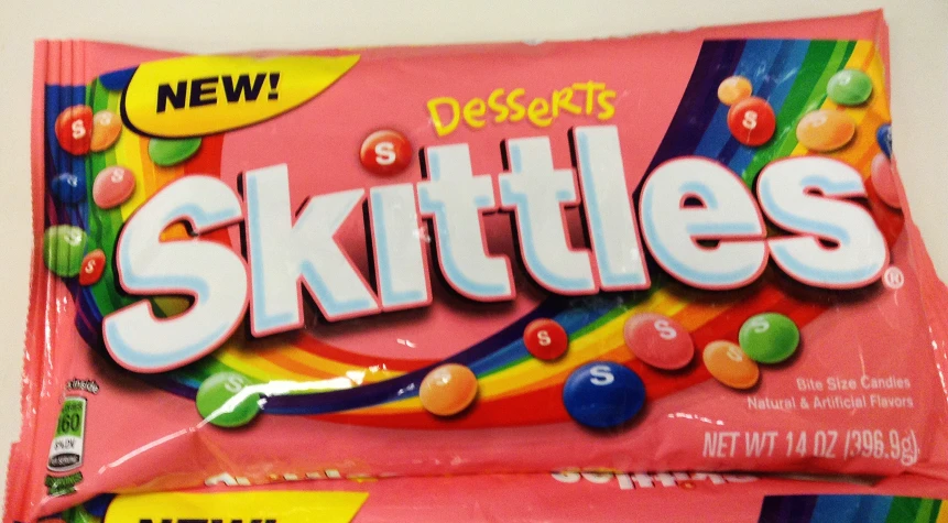 a close up of skittles candy bar