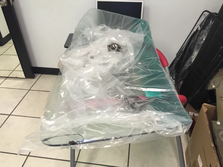 an ironing board with a large plastic sheet on it