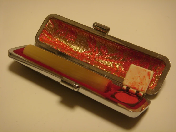 a red clutch purse is sitting on the table