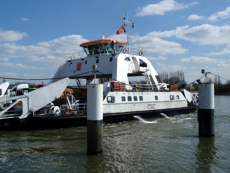 a white boat is going down the water