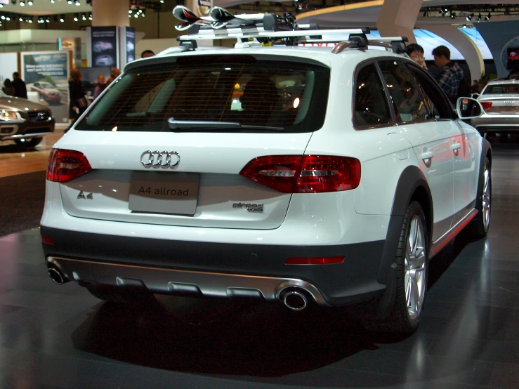 a white audi with a roof rack on it's back