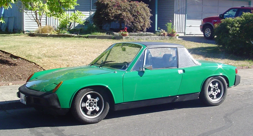 a green car parked on the side of the road