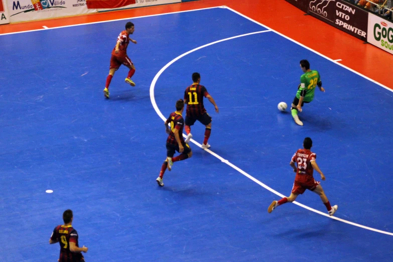 several teams playing a game of soccer in front of a crowd