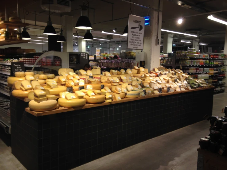 a grocery store with a variety of cheese items