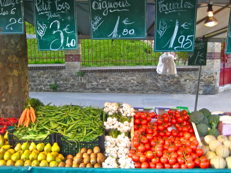 a store with vegetables on display under tables