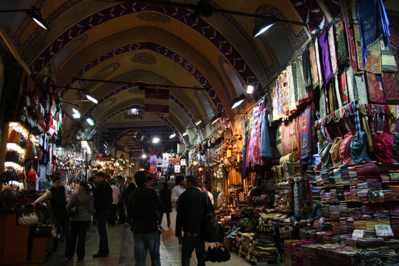 the people are shopping in the busy market area