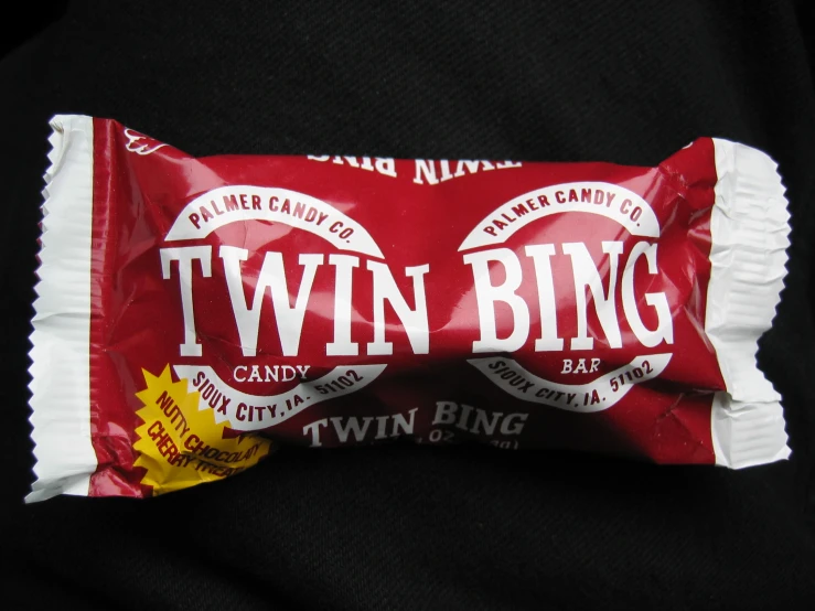 two - bit candy bar wrapped in paper and sitting on top of each other