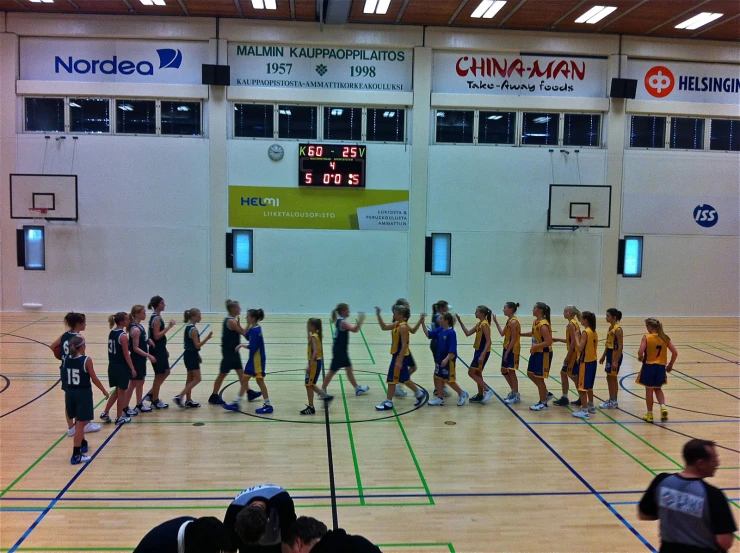 basketball players are playing in a gymnasium