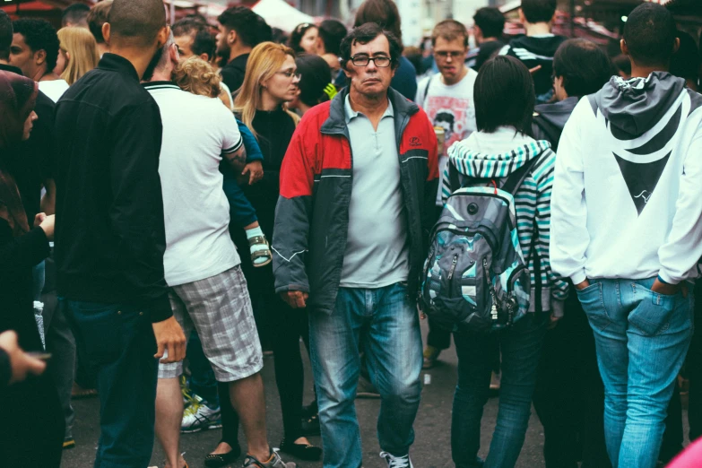 a bunch of people in the street standing together