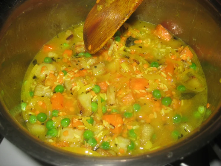 someone is cooking a vegetable meal in a pot