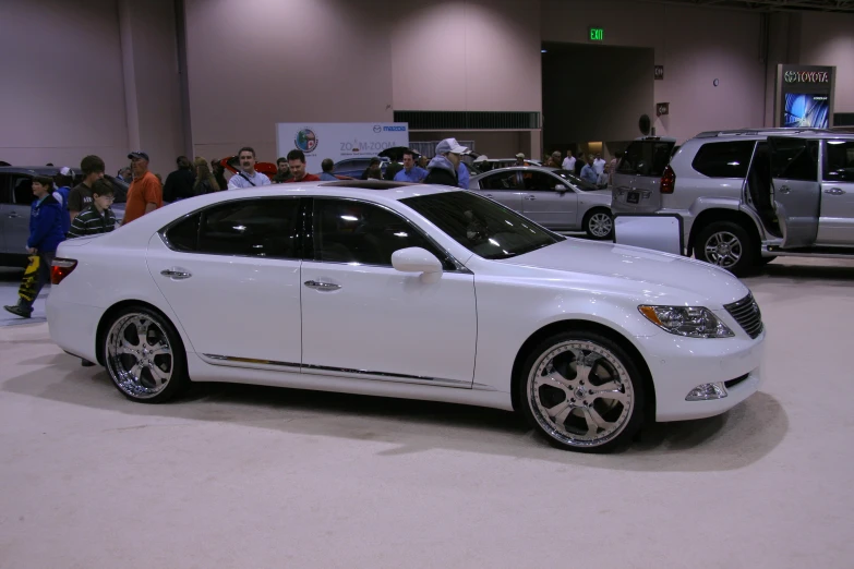 a white car is on display in the showroom