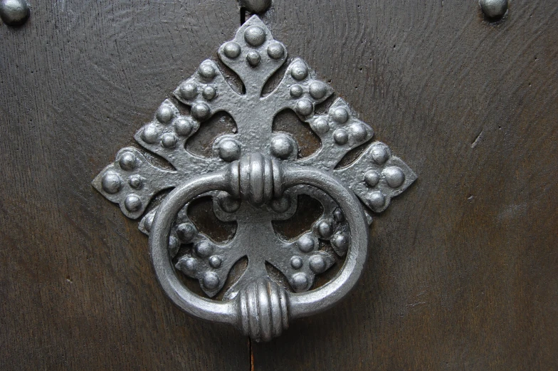 the door knocket has been painted silver and is decorated with metal rivets