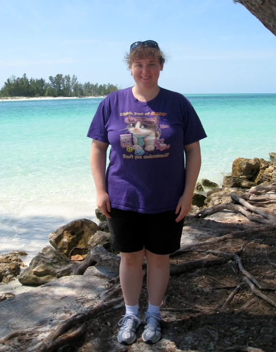 a person standing near water with a tree