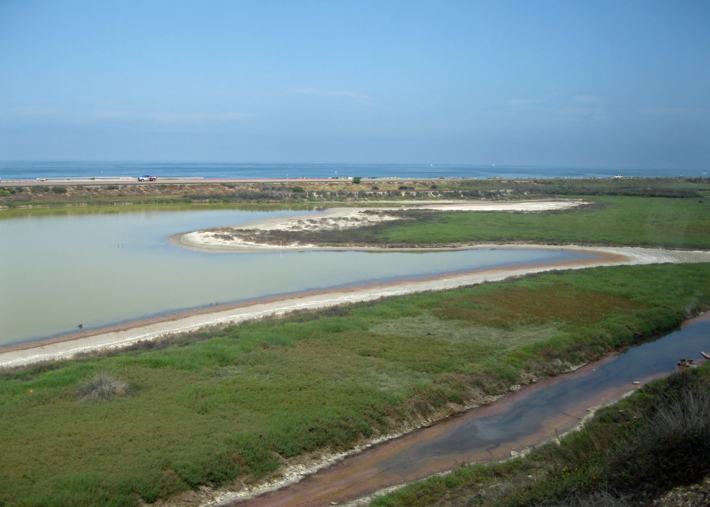 a river is shown next to the grass field